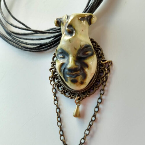 pendant with a joker face by ursula aavasalu tigukass