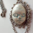 pendant with a sleeping face by ursula aavasalu tigukass