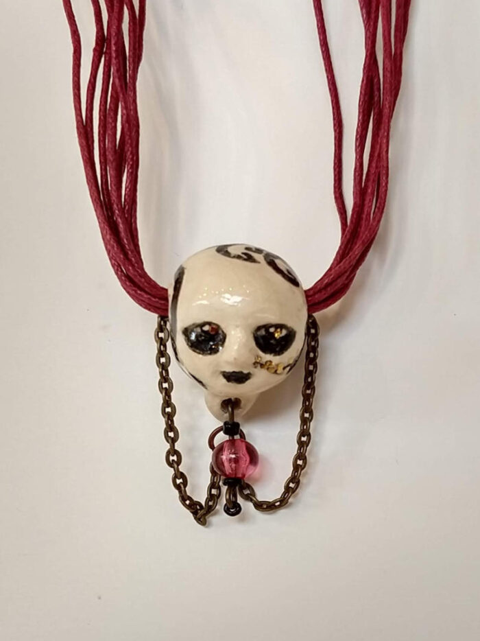 smiling head necklace by ursula aavasalu tigukass